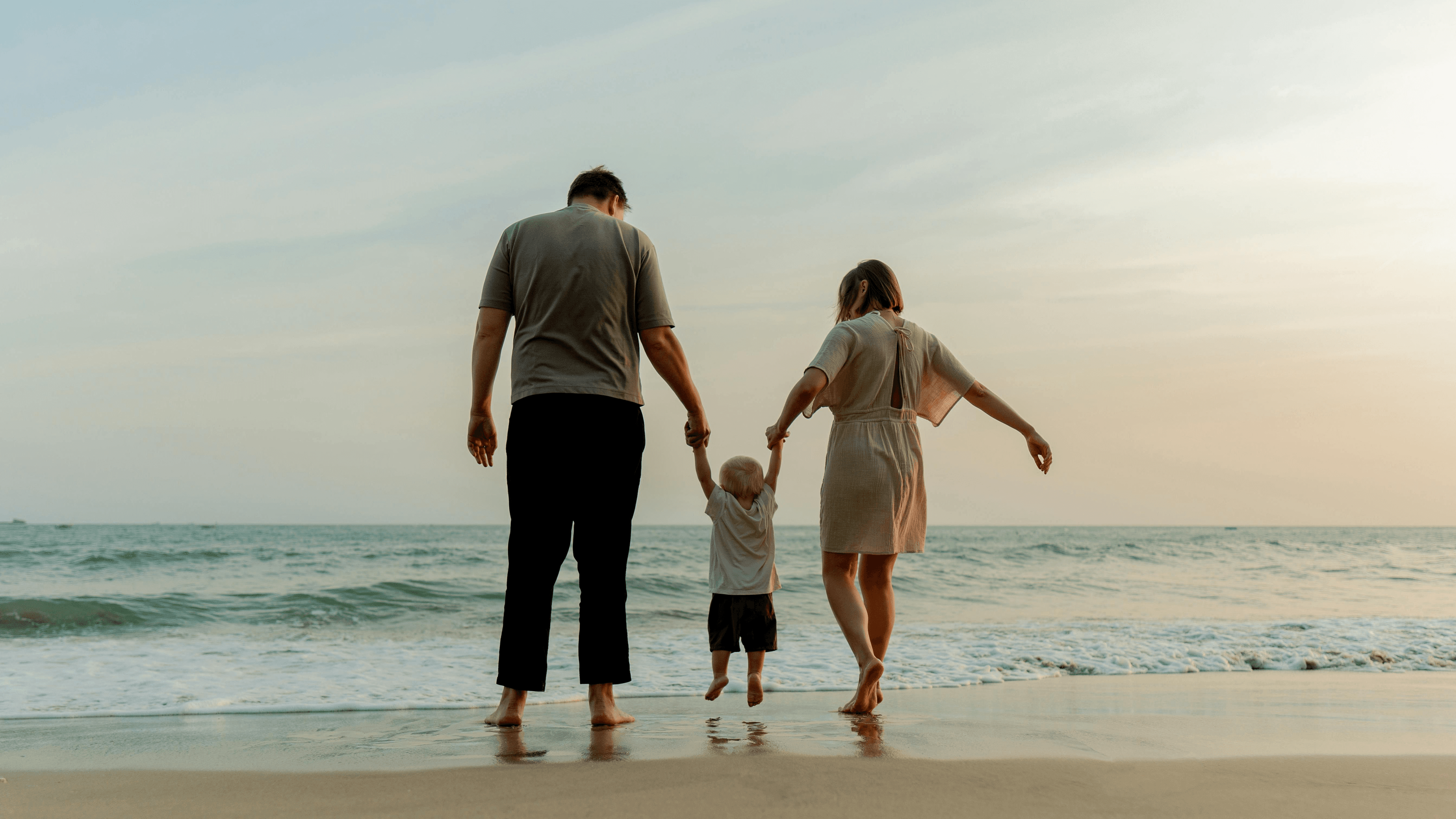 Family walking together on the beach