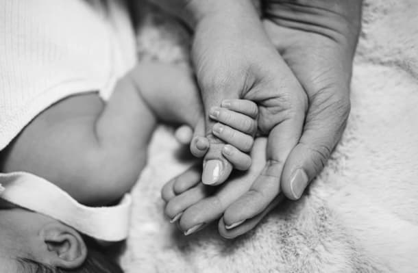 Baby holding a parent's hand