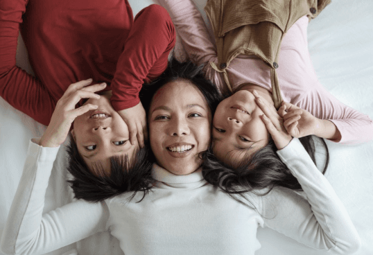 Mother lying down with her children